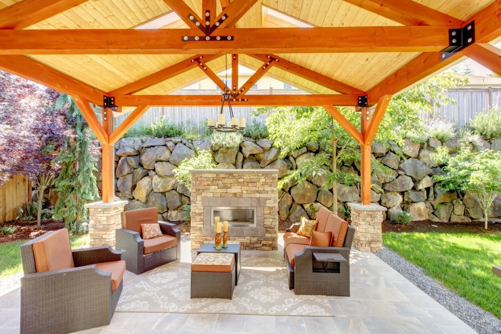  covered patio with fireplace and furniture