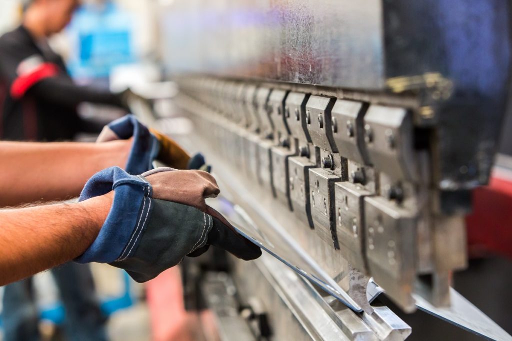 men working in a sheet metal press brakes machine
