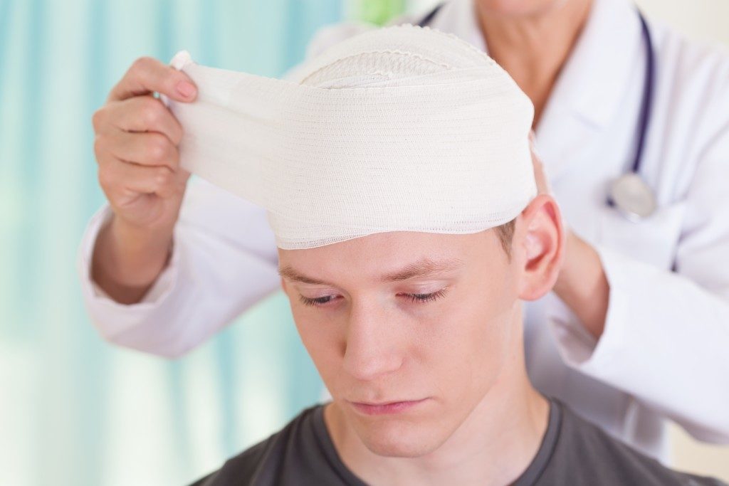 man with concussion being treated
