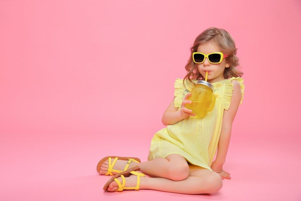 child model on pink background and yellow outfit