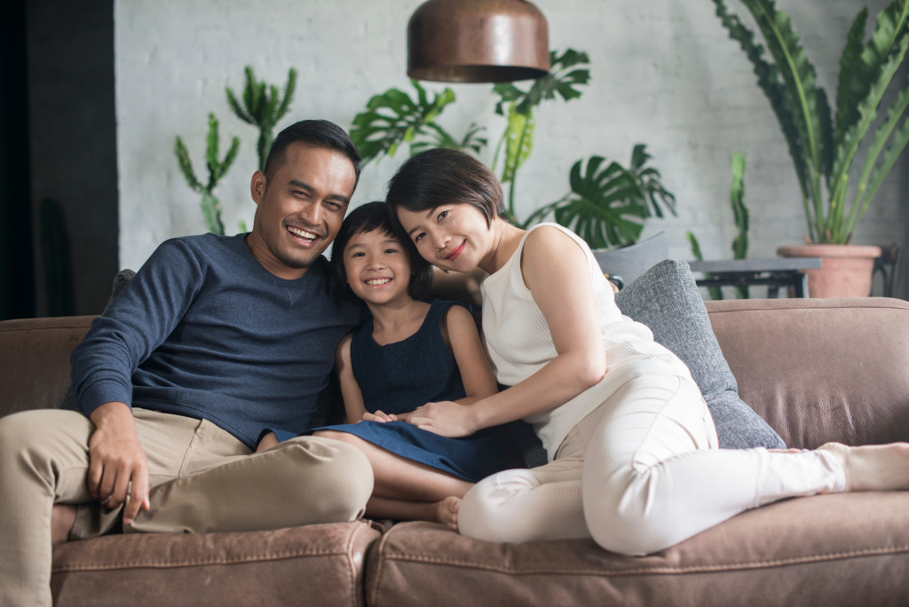 family smiling in couch