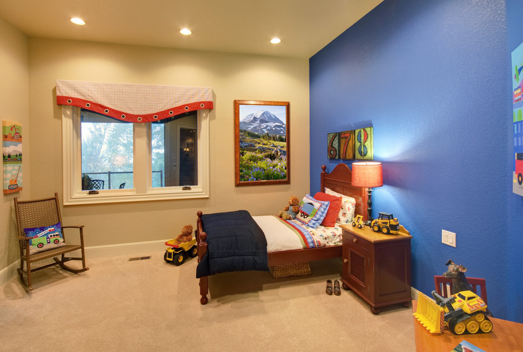 Kids room with bed chair and lot of toys 