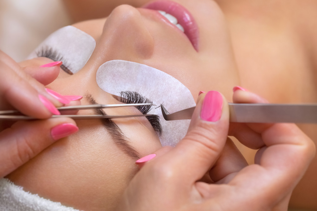 A woman getting a lash lift and extensions in a salon