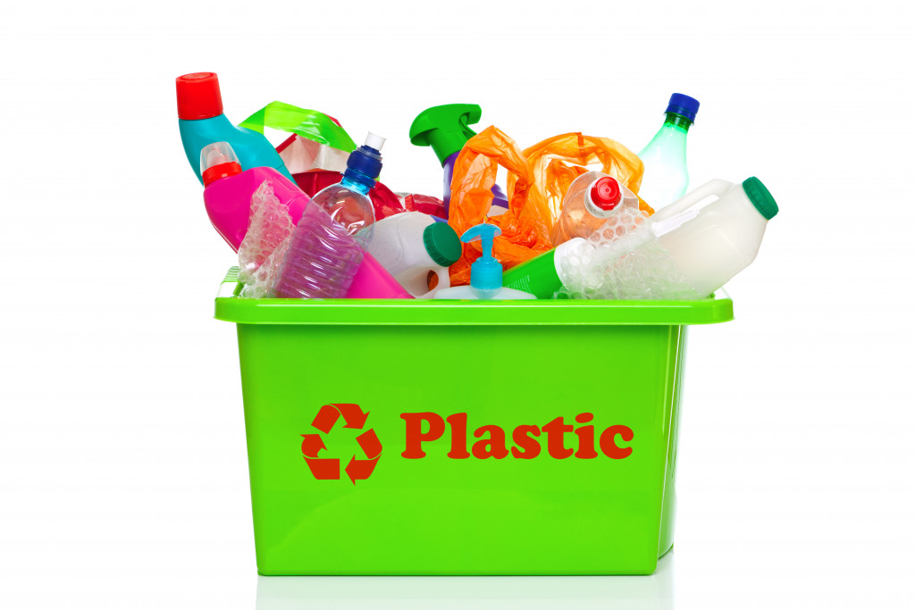 Plastic recycling bin full of bottle to get recycle with a symbol of plastic recycle