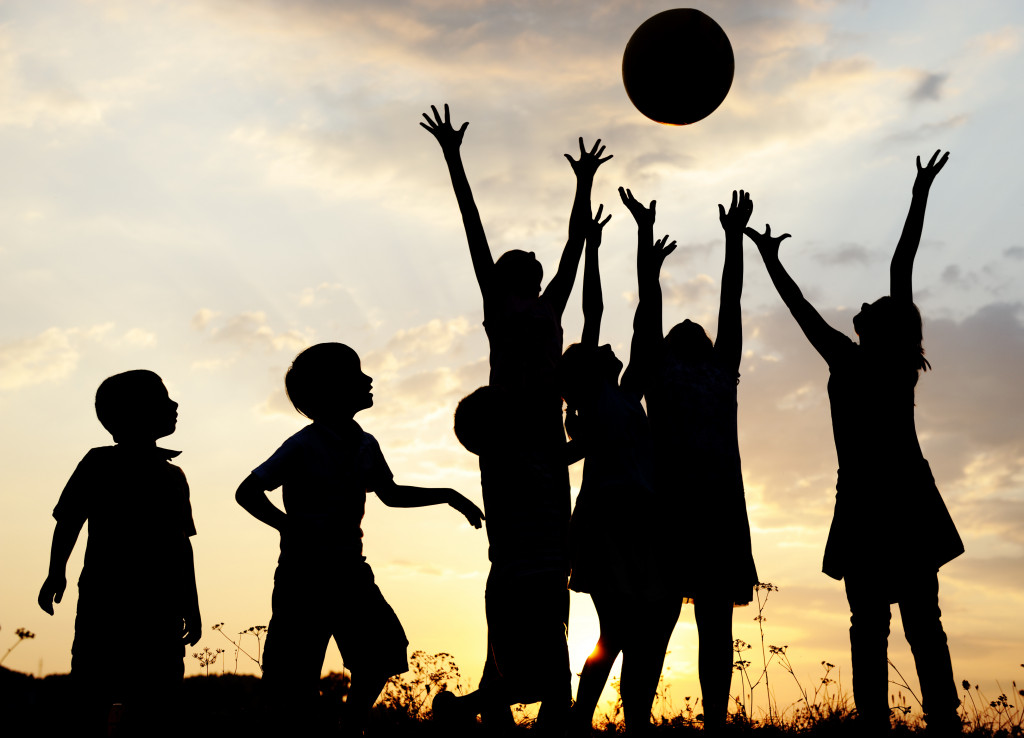 Children playing sports with friends