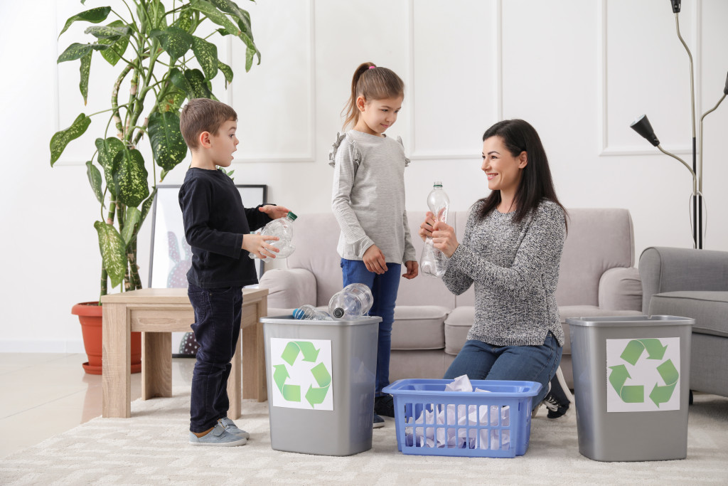 a mom showing kids the basics of recycling at home