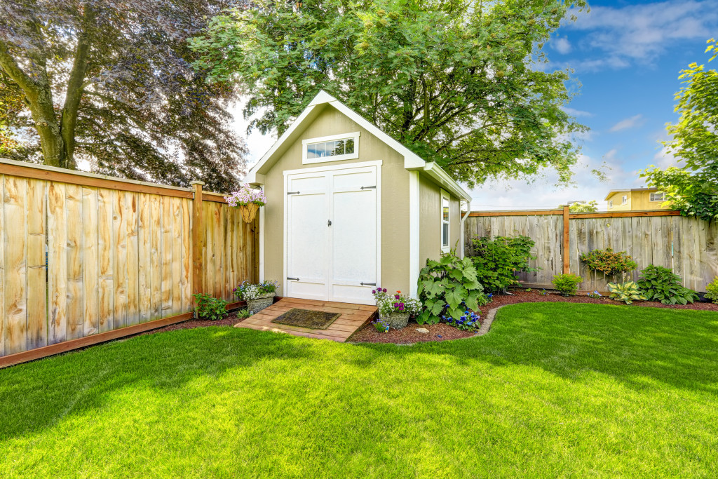 Beautiful new shed with flower bed on backyard area with fences