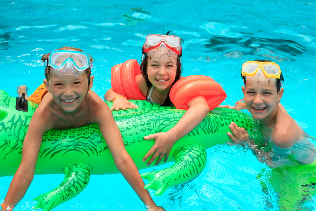 Three children in a pool