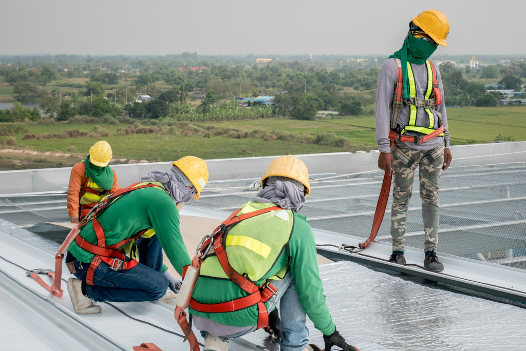 Workers installing roofing on a commercial building.