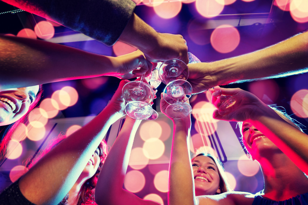 A group of people toasting glasses in a blurry night club