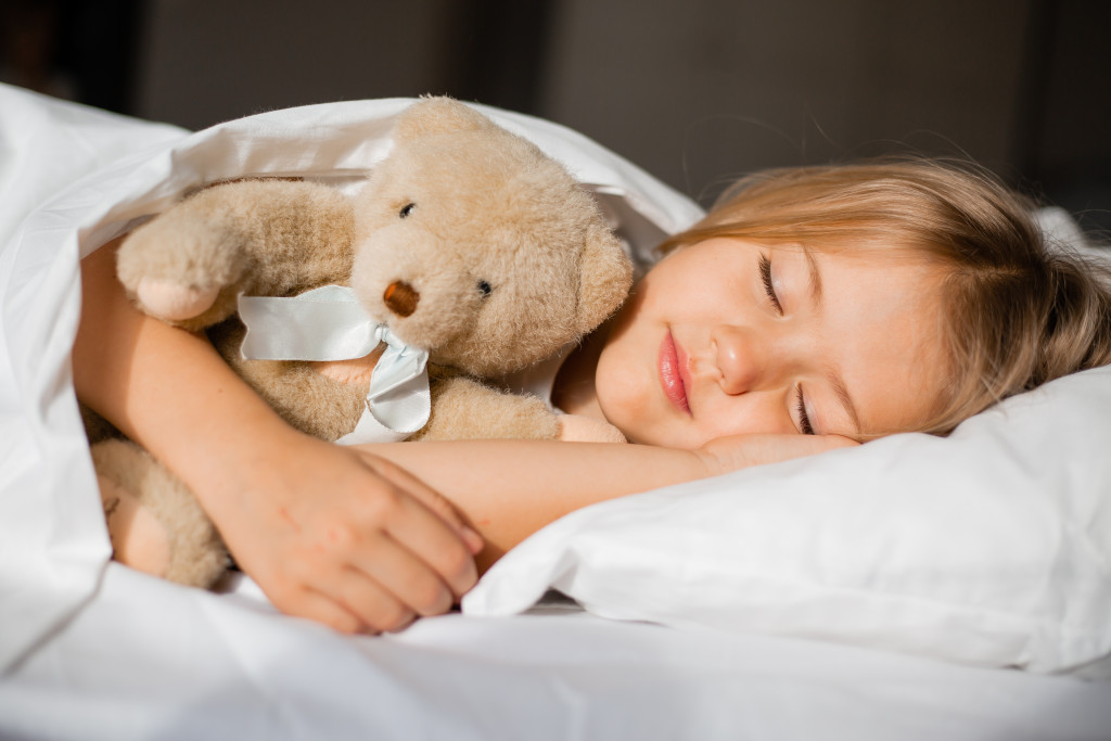 A little girl having a good night's sleep with stuffed toy