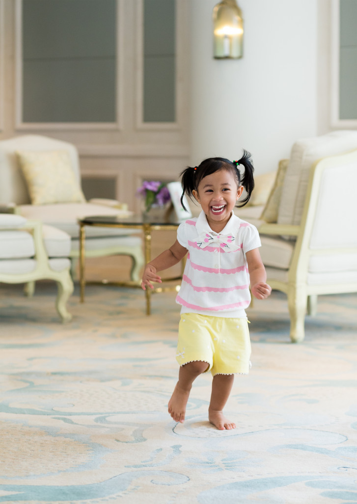 Small girl running in her house and smiling