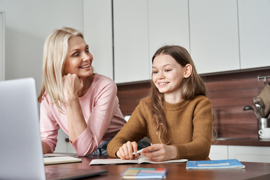 A mom helping her daughter learn at home
