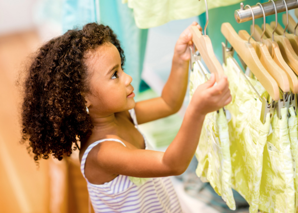 Young girl shopping for clothes at a retail store