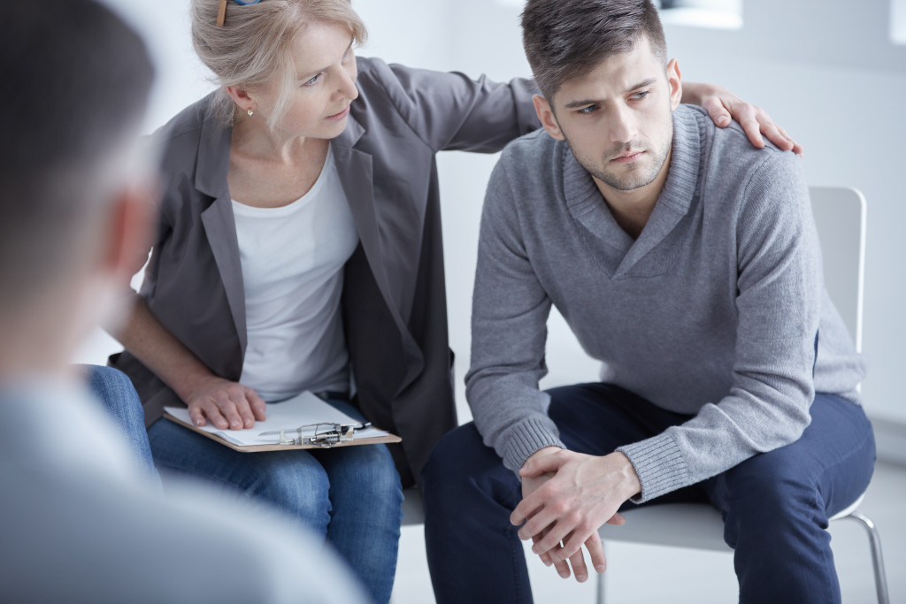 Psychotherapist supporting a young man to deal with stress.