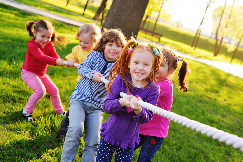 kids happily tugging on a rope playing outdoors