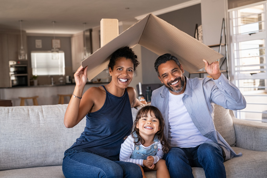 happy family with cardboard on top of parents 