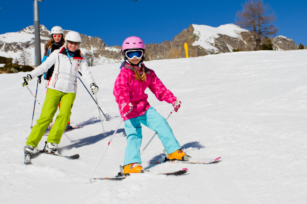 Children skiing on the mountainside at a resort.