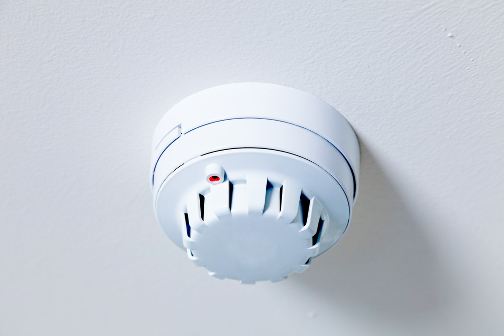 A smoke detector on a ceiling