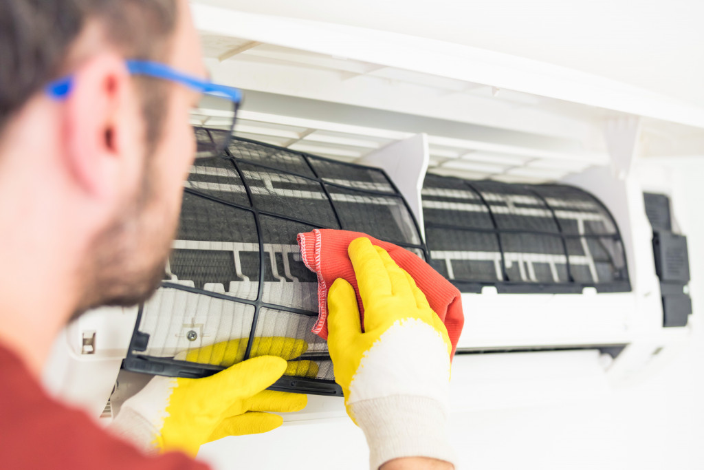 A man cleaning air filters